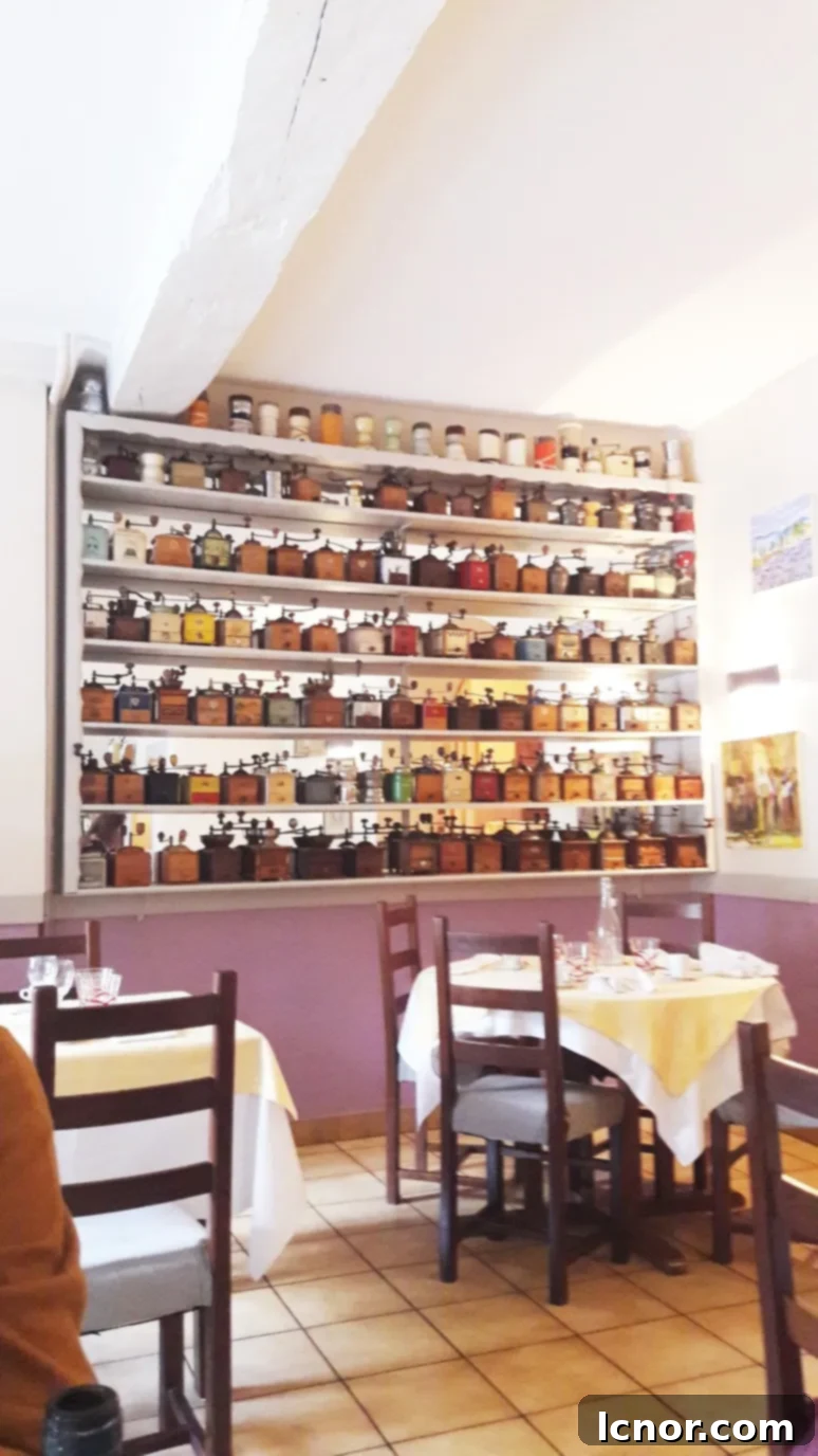 Interior of Le Saint Père restaurant in Tonnerre, Burgundy, France, known for its antique coffee grinder collection and local cuisine. A Hedgehog in the Kitchen.