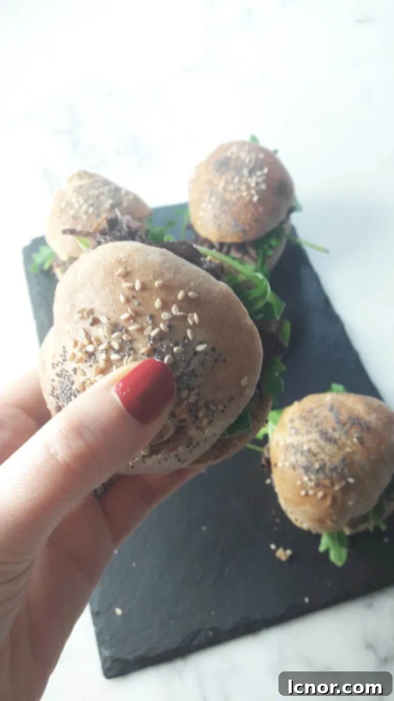 Close-up of a mini Boeuf Bourguignon burger, showing the rich beef filling and fluffy homemade bun.