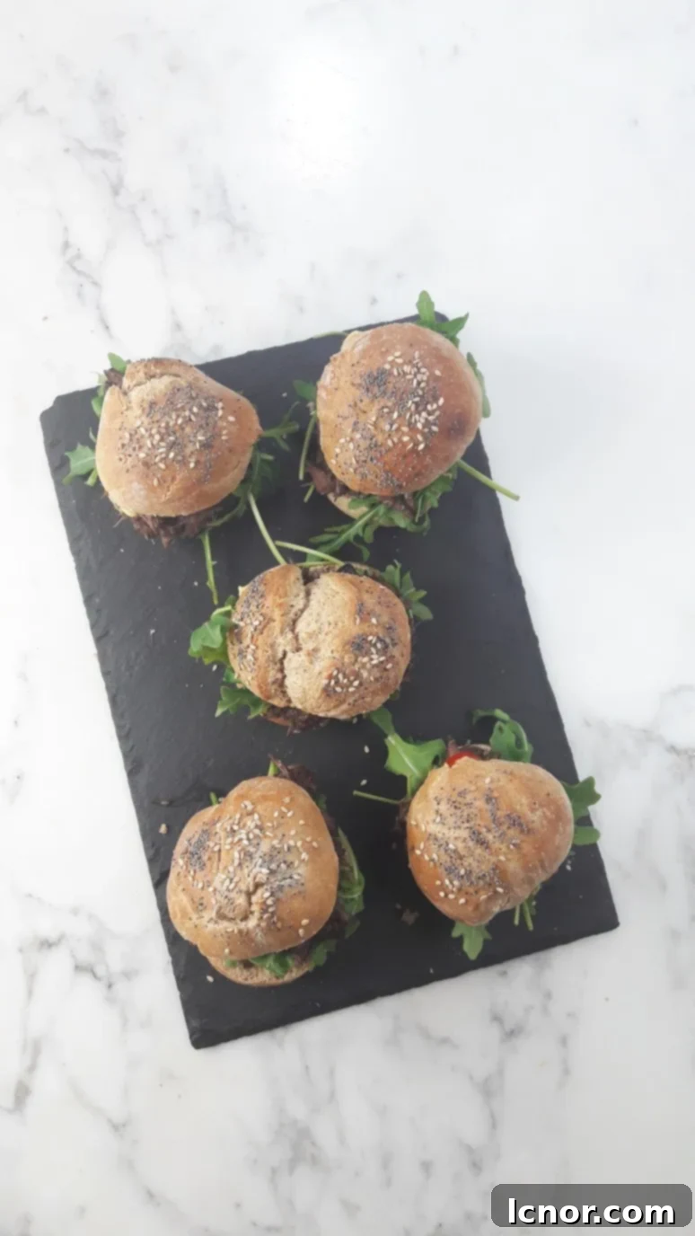 Beautifully arranged mini Boeuf Bourguignon burgers with fresh garnishes.