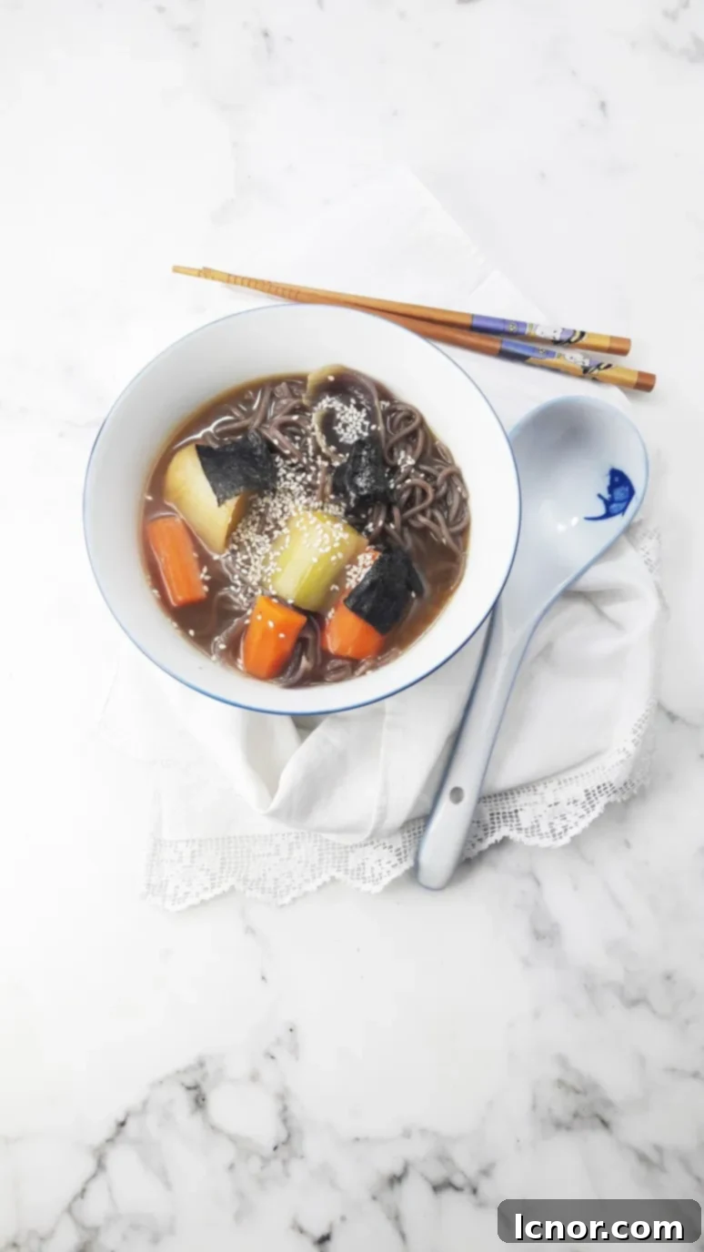 Close-up of miso soup with leeks and carrots, ready to be served.