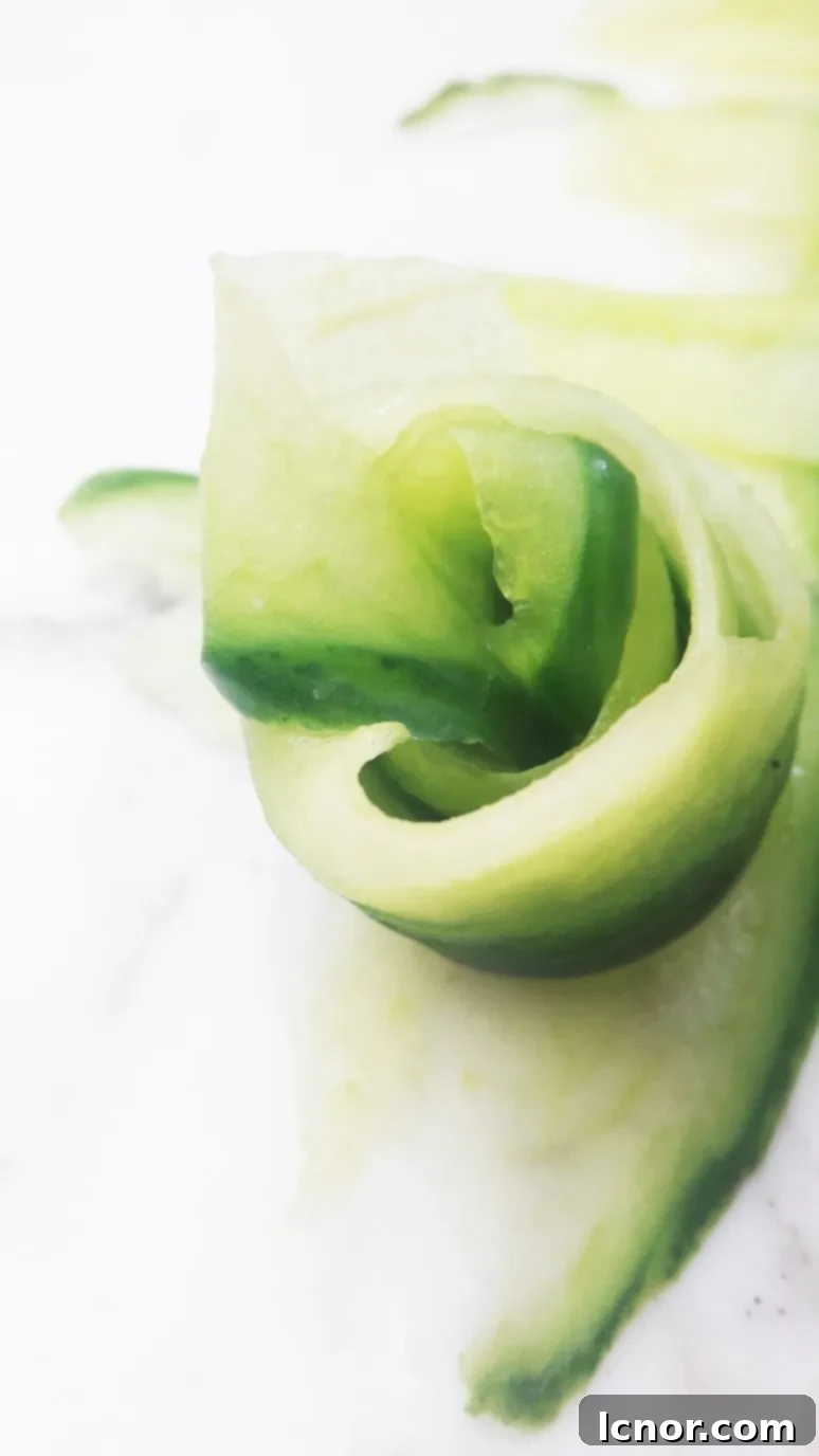 Detailed shot of an intricately woven cucumber mat with vegan sushi, enhanced with a delicate cucumber rose garnish.