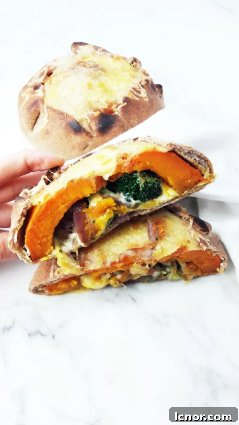 Savory pumpkin calzone filled with broccoli, mozzarella, and creamy ricotta cheese, offering a delicious and nutritious meal.