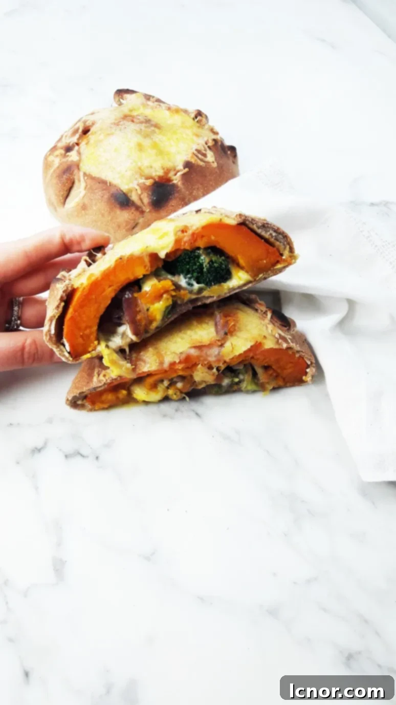 Freshly baked pumpkin calzone, golden brown, resting on a wooden board.