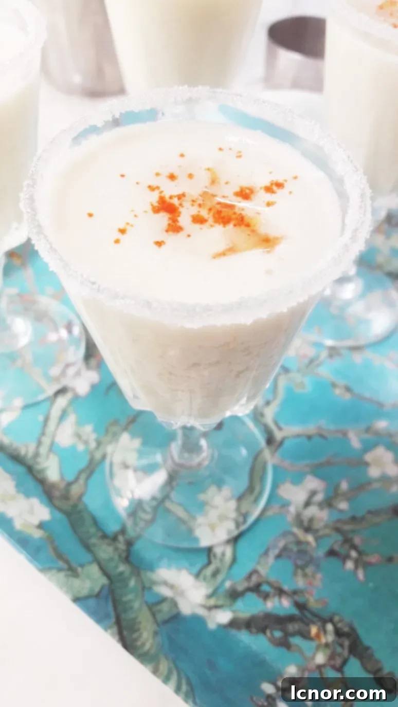 Tropical mini Pina Colada cocktails served alongside small bites, perfect for apéro.