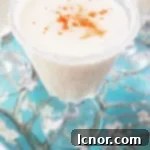 Tropical mini Pina Colada cocktails served alongside small bites, perfect for apéro.