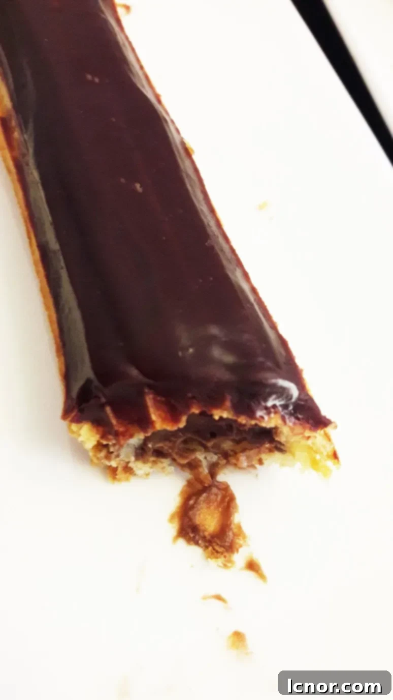 A close-up of the delectable chocolate éclair from Paris Baguette, highlighting its rich texture and appealing presentation.