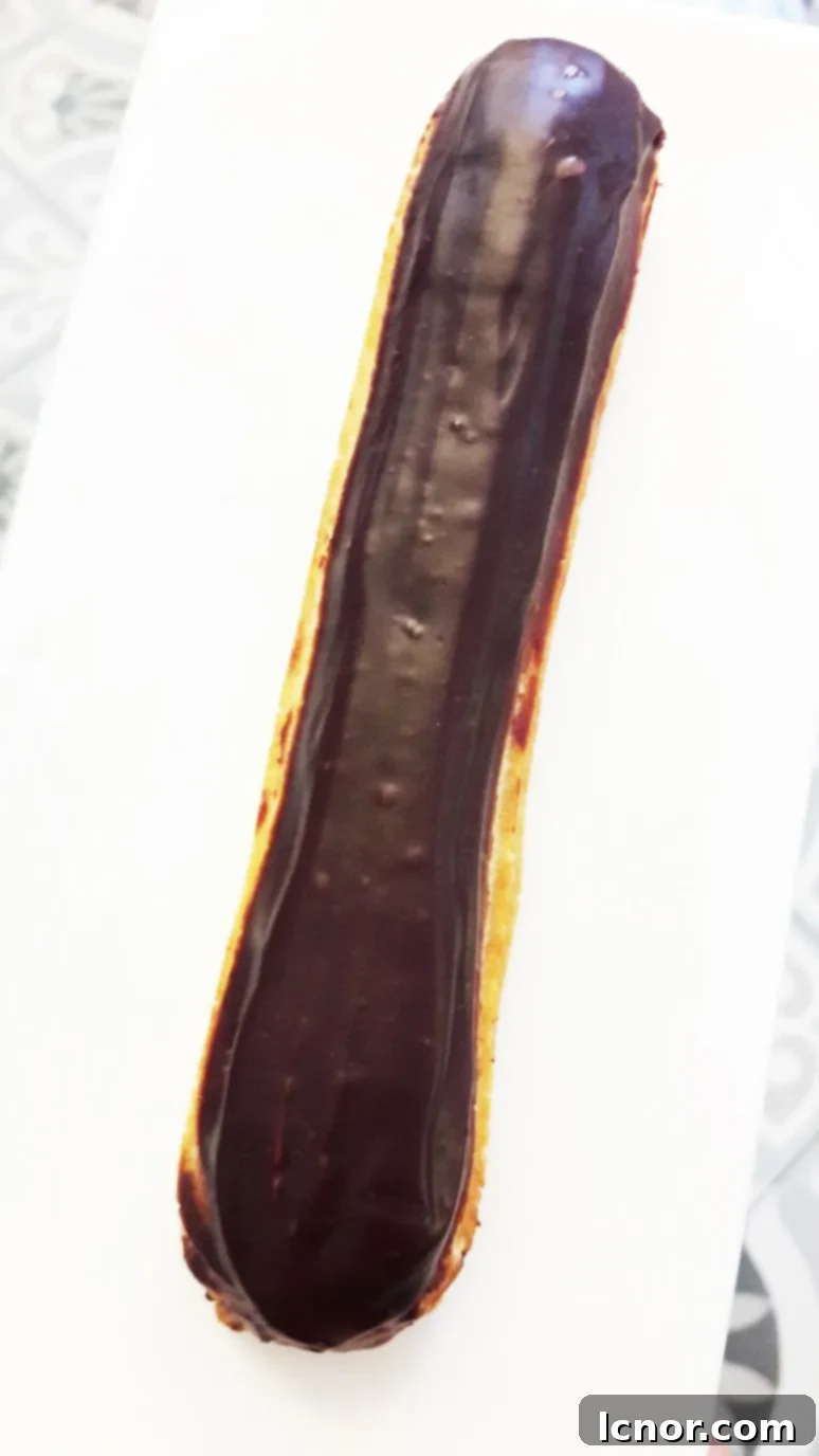The alluring chocolate éclair from Paris Baguette, showcasing its decadent filling and perfectly baked pastry shell.