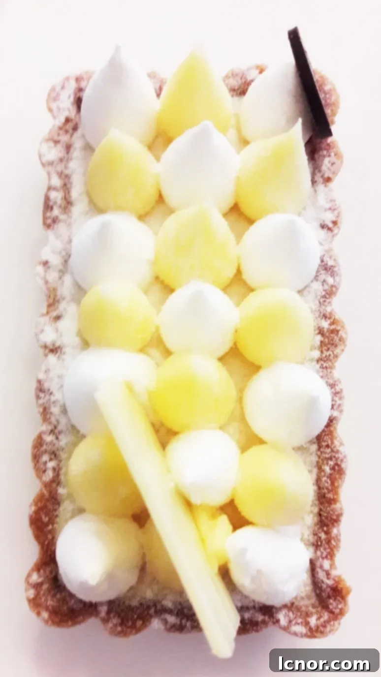 A close-up of the exquisite lemon meringue tart at Paris Baguette, featuring perfectly golden meringue and a luscious lemon filling.