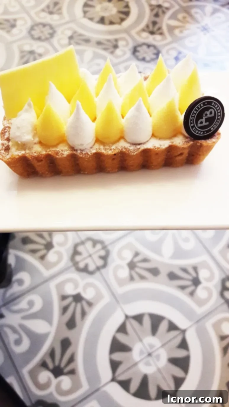 A closer look at the perfectly portioned lemon meringue tart, ideal for a decadent individual treat or shared dessert.