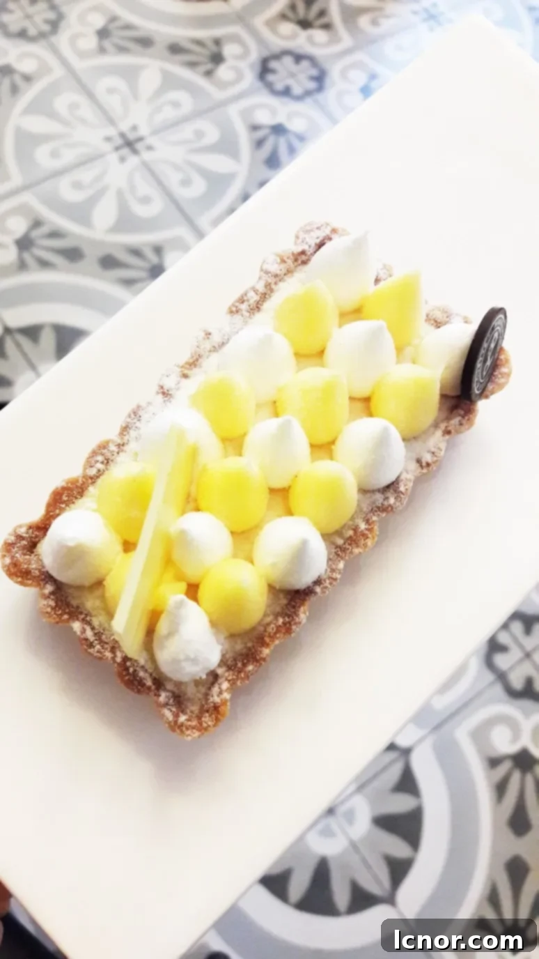 A tantalizing view of the lemon meringue tart, showcasing its fluffy meringue and rich lemon filling, a top pastry in Paris.