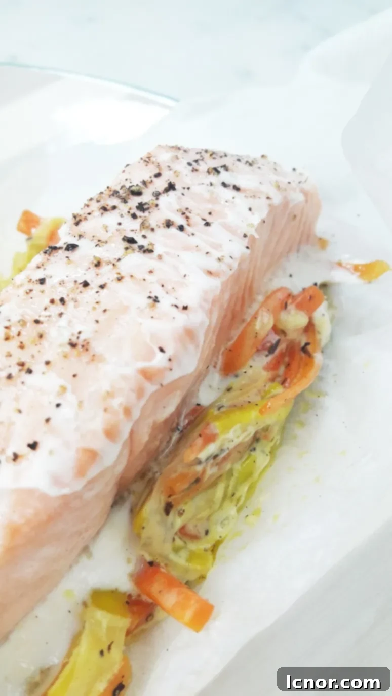 Fresh leeks and carrots, julienned and ready for cooking, representing the wholesome ingredients in this salmon recipe.