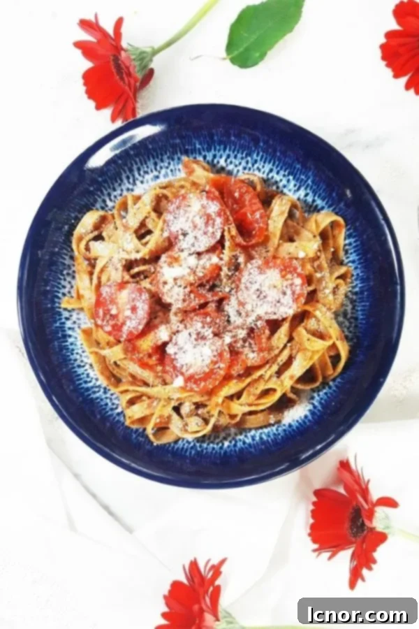 a blue bowl with tagliatelle and ragu sauce