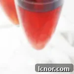 A vibrant Kir Breton cocktail in a champagne flute, ready to be enjoyed, showcasing the beautiful blend of blackcurrant and apple cider.