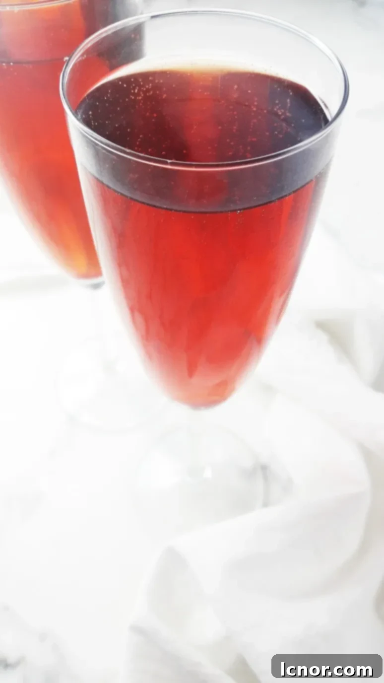 A refreshing Kir Breton cocktail, showcasing the vibrant colors of blackcurrant and apple cider, perfect for spring gatherings.