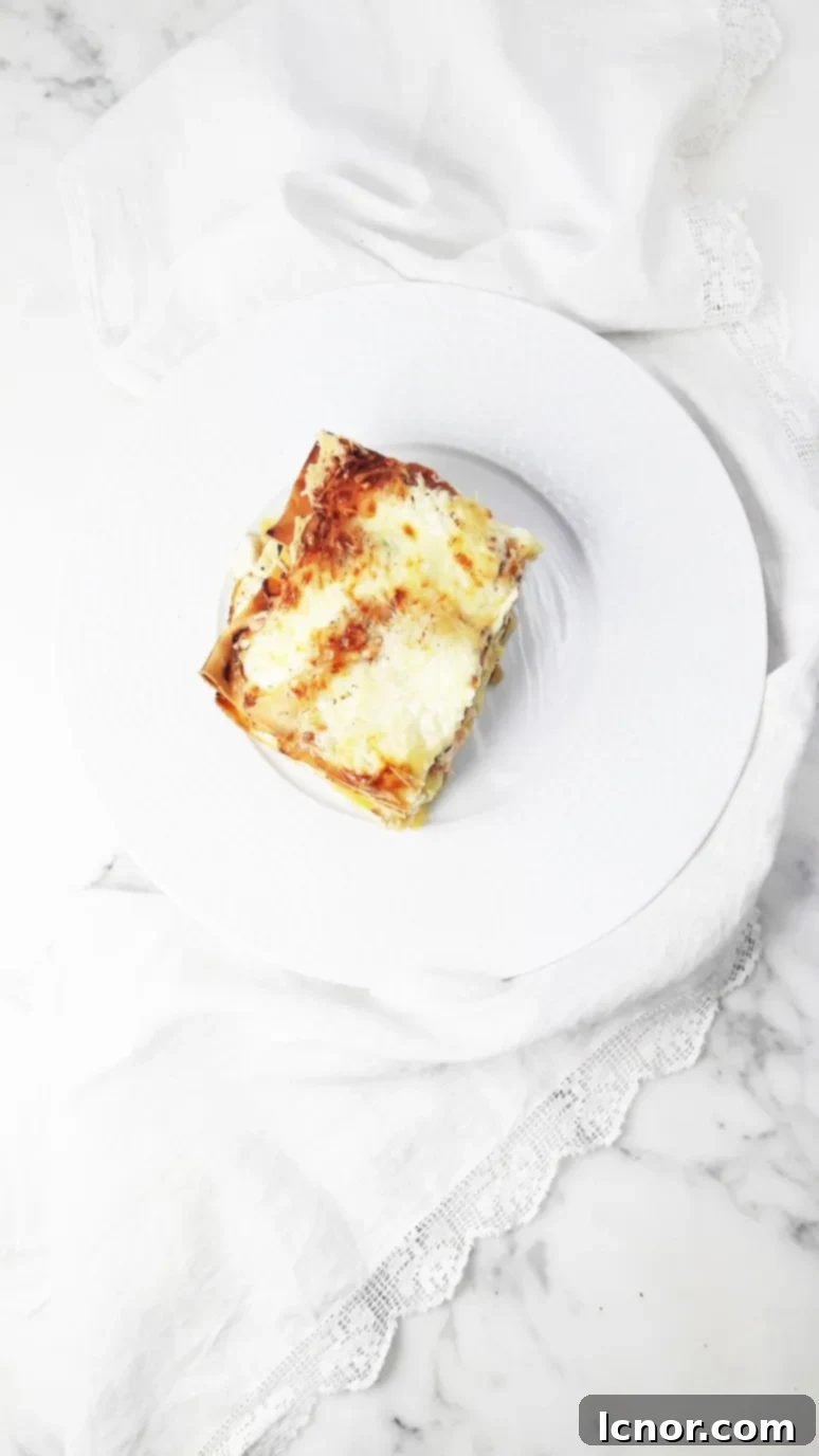 Close-up of the delectable layers of salmon, zucchini, and creamy cheese in our baked lasagna. A comforting and quick family dinner recipe.