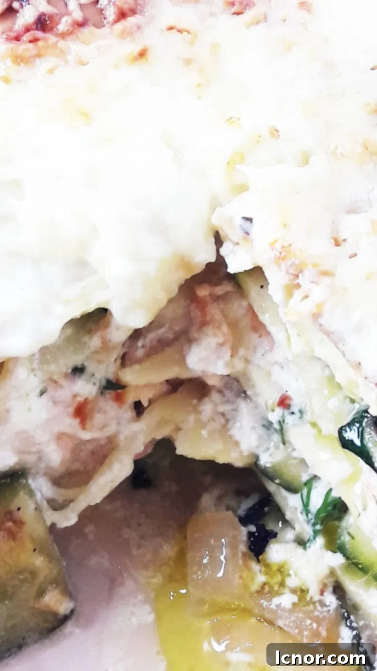Close-up of a serving of salmon zucchini lasagna, showing the delicate salmon flakes and tender zucchini slices.