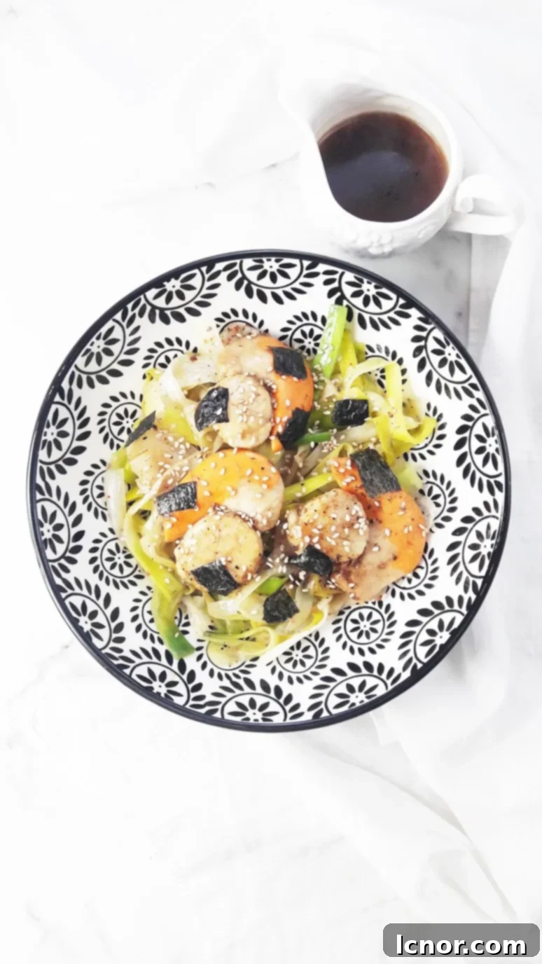 Perfectly seared Japanese scallops with vibrant green leek noodles, drizzled with a rich miso sauce, presented on a white plate. A quick, healthy, and flavorful Japanese dinner recipe.
