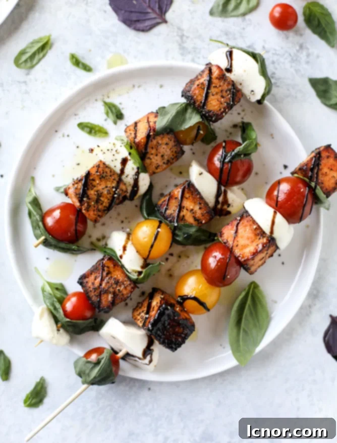 Delicious 30-minute blackened salmon caprese skewers with cherry tomatoes, mozzarella, and basil.
