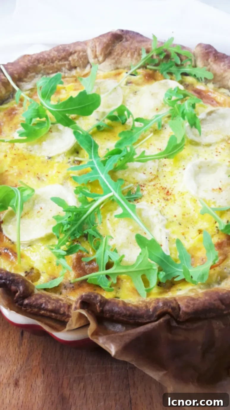 A close-up of the delicious Goat Cheese Zucchini Quiche, highlighting the creamy texture and rich ingredients within.