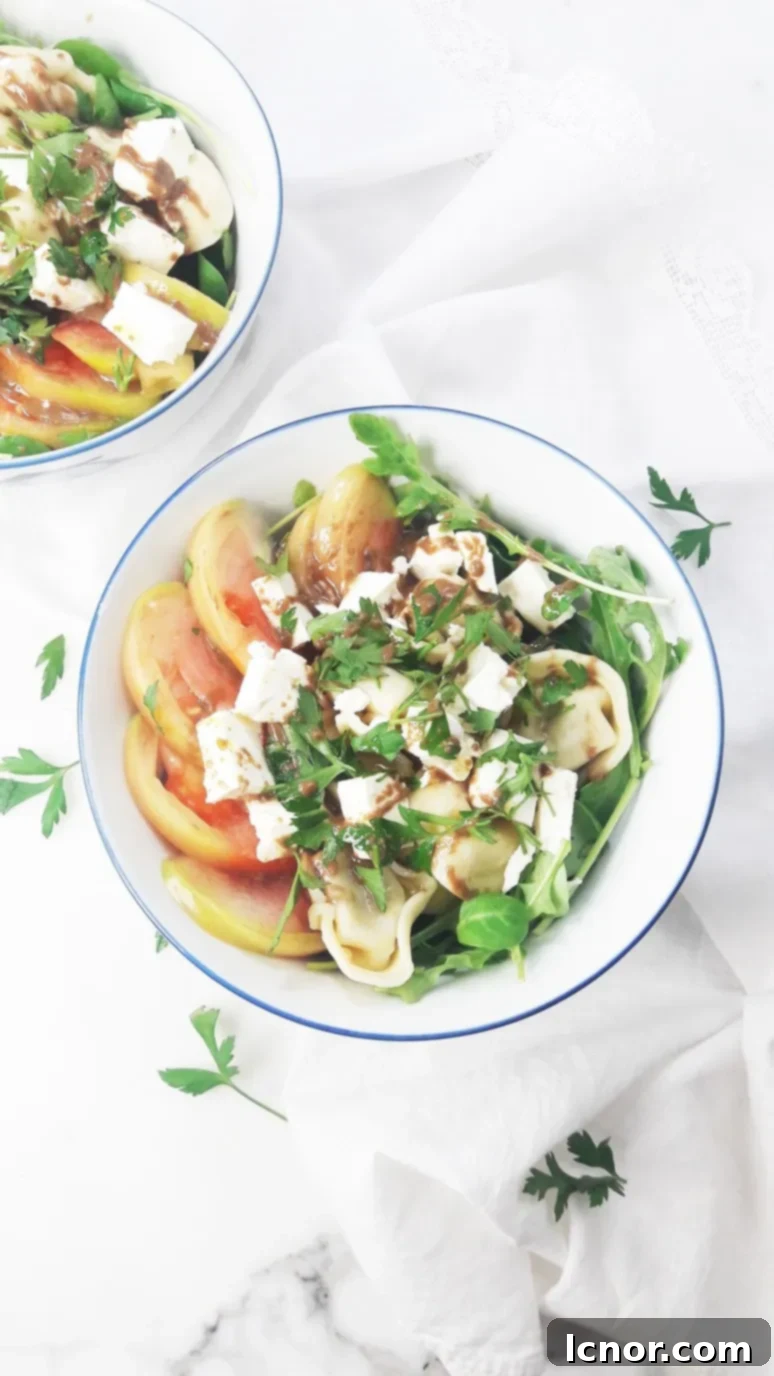 This tomato feta tortellini salad is a perfect healthy picnic staple. YUM. Just 8 simple ingredients & 10 minutes to pull together! | ahedgehoginthekitchen.com