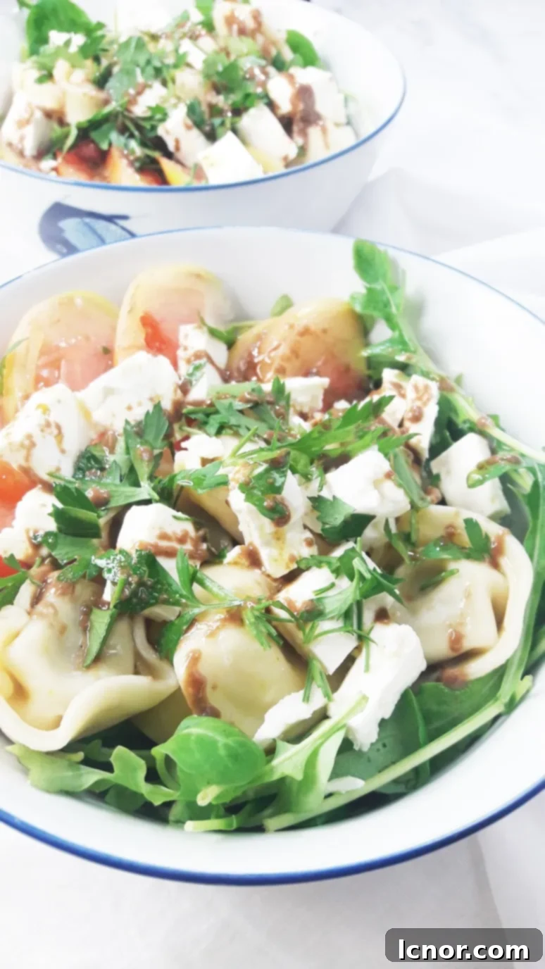 This tomato feta tortellini salad is a perfect healthy picnic staple. YUM. Just 8 simple ingredients & 10 minutes to pull together! | ahedgehoginthekitchen.com