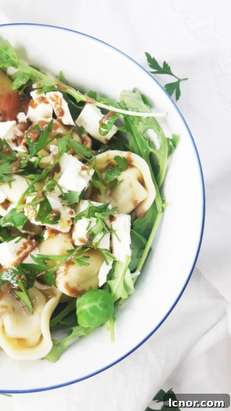 This tomato feta tortellini salad is a perfect healthy picnic staple. YUM. Just 8 simple ingredients & 10 minutes to pull together! | ahedgehoginthekitchen.com