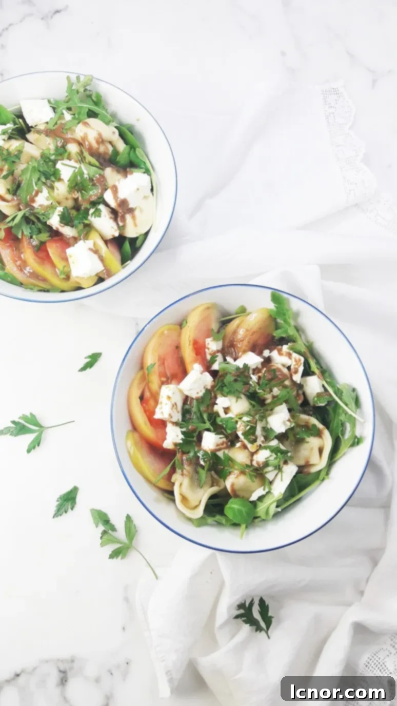 This tomato feta tortellini salad is a perfect healthy picnic staple. YUM. Just 8 simple ingredients & 10 minutes to pull together! | ahedgehoginthekitchen.com
