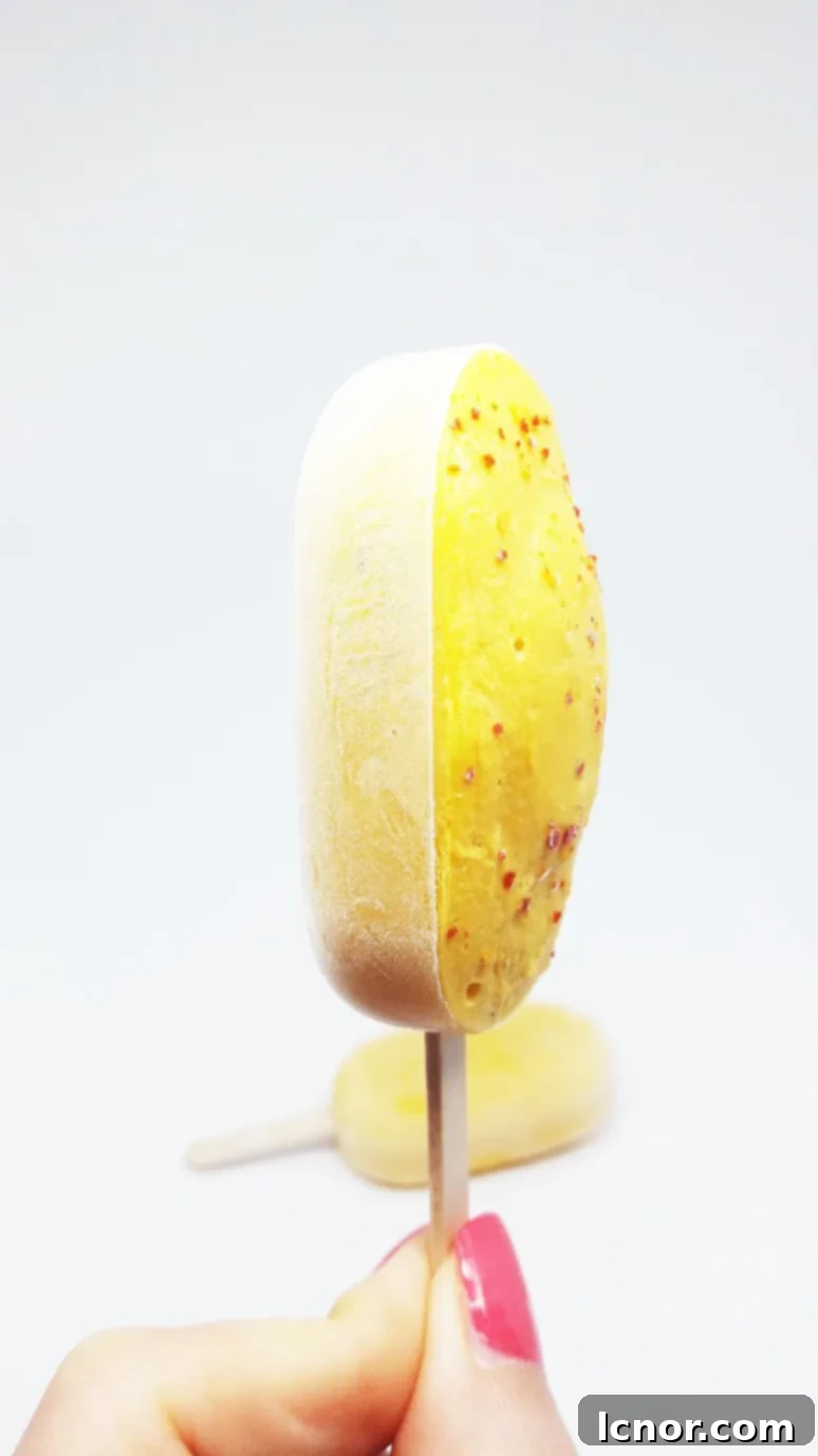 Close-up of Mango Lassi Popsicles showing the creamy texture and hint of pepper, a naturally refreshing and healthy summer dessert. | ahedgehoginthekitchen.com