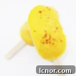 Homemade Mango Lassi Popsicles: Creamy, fruity, and subtly spicy – the ultimate refreshing summer treat. | ahedgehoginthekitchen.com