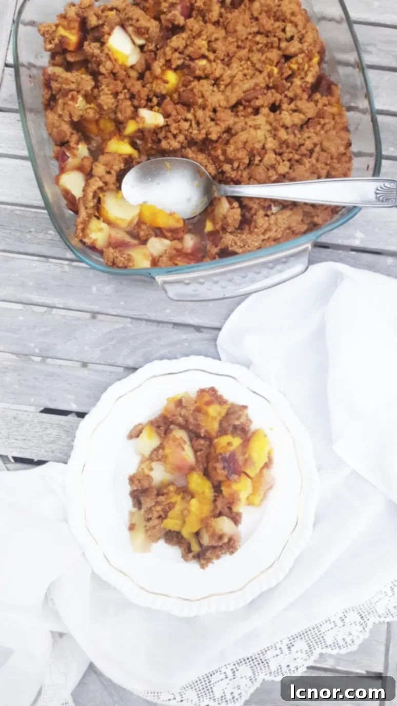 Mixing butter with sugar, flour, and crushed speculoos cookies by hand to create the perfect crumble topping for the peach nectarine mango dessert. | ahedgehoginthekitchen.com