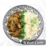 overhead photo of Burmese chicken curry with coconut rice in a bowl