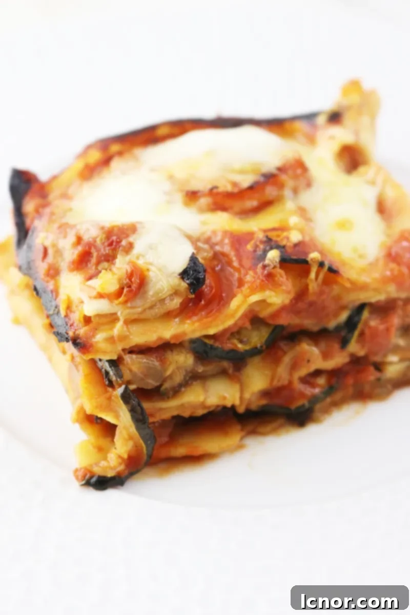 A serving of Roasted Eggplant Lasagna on a plate, ahedgehoginthekitchen.com