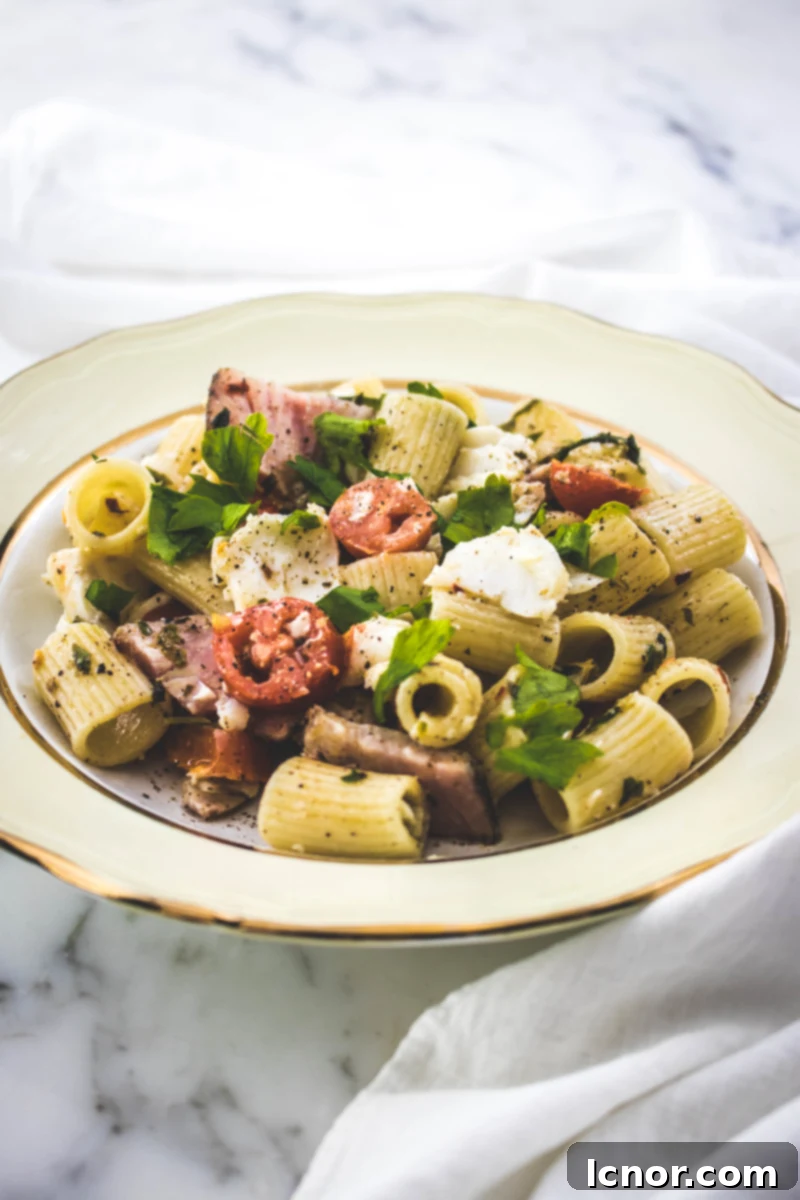 Delicious fish pasta with flaky cod, savory tuna pastrami, and juicy cherry tomatoes