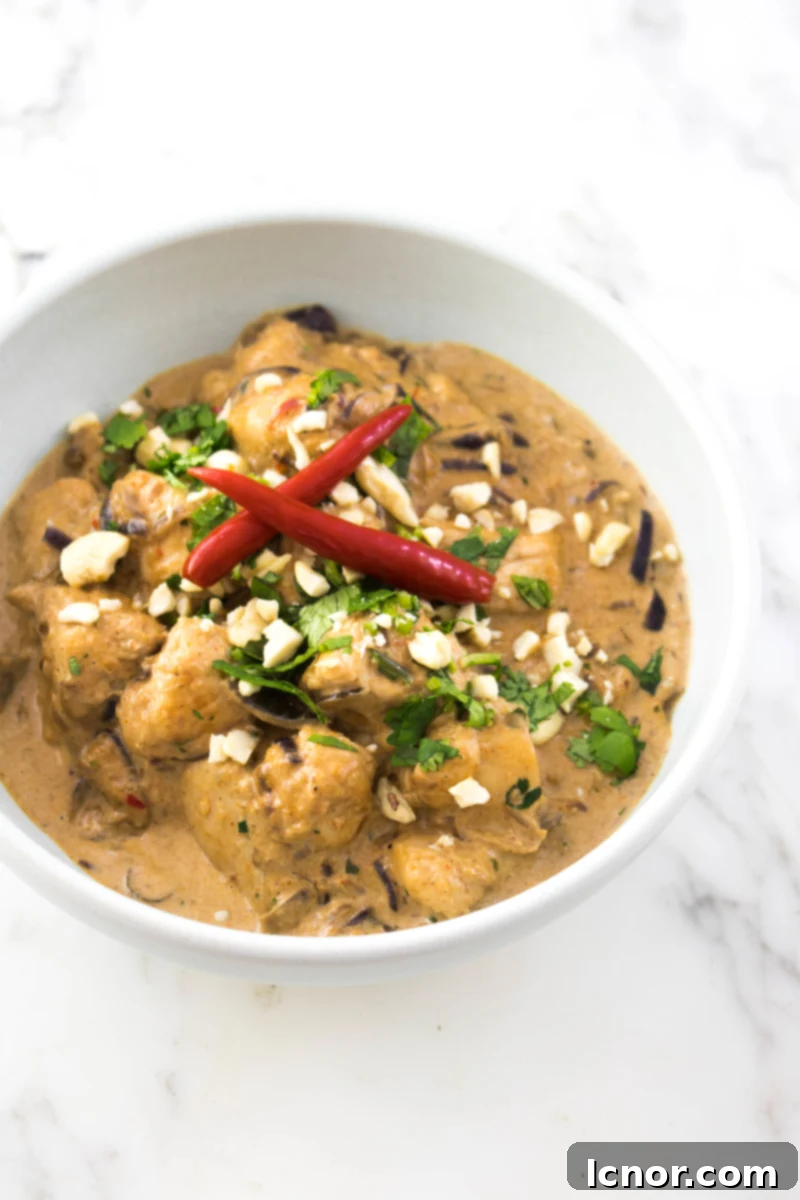 A bowl of delicious Thai Red Curry Chicken served with rice, made with homemade red curry paste.