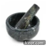 A sturdy black marble pestle and mortar, ideal for grinding spices for curry paste.