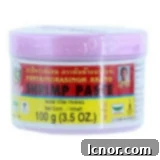 A jar of authentic shrimp paste, an essential ingredient for Thai Red Curry Paste.