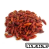 A pile of fresh, vibrant organic bird's eye chilies for authentic Thai spice.