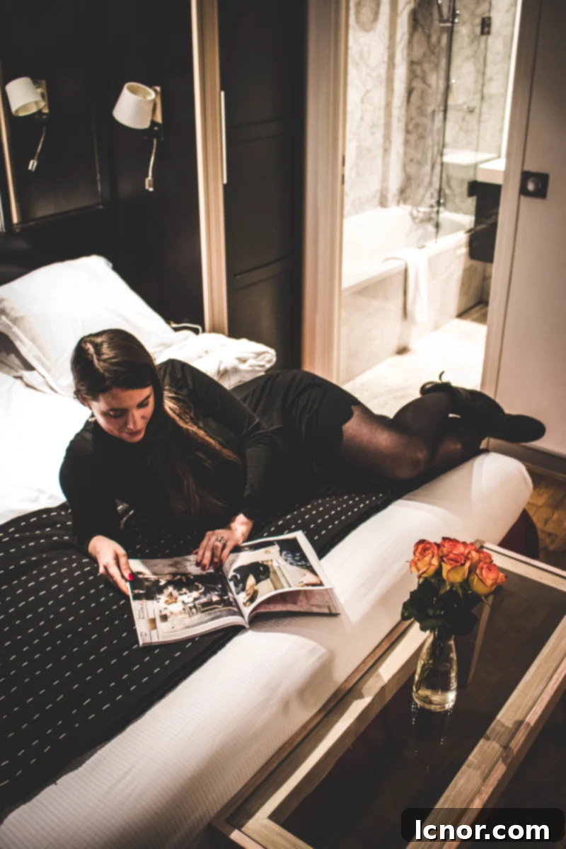 Comfortable bed with elegant linen in a Hotel du Jeu de Paume guest room.