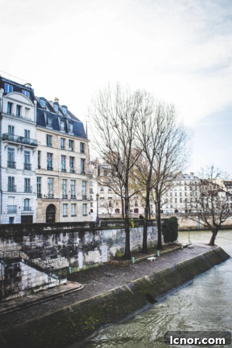 Charming street scene on Ile Saint Louis, Paris, with traditional buildings.