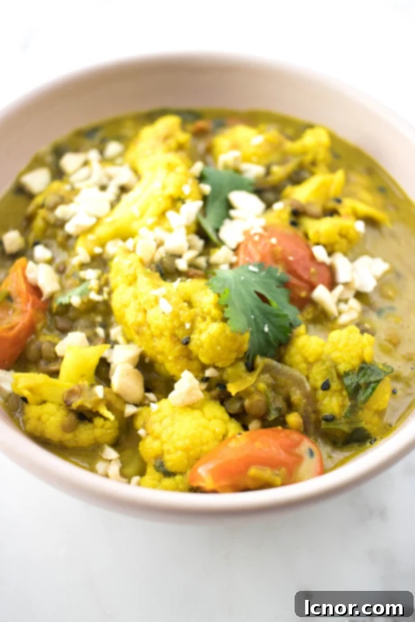 Delicious and creamy Kerala Cauliflower Curry, garnished with fresh cilantro and cashews