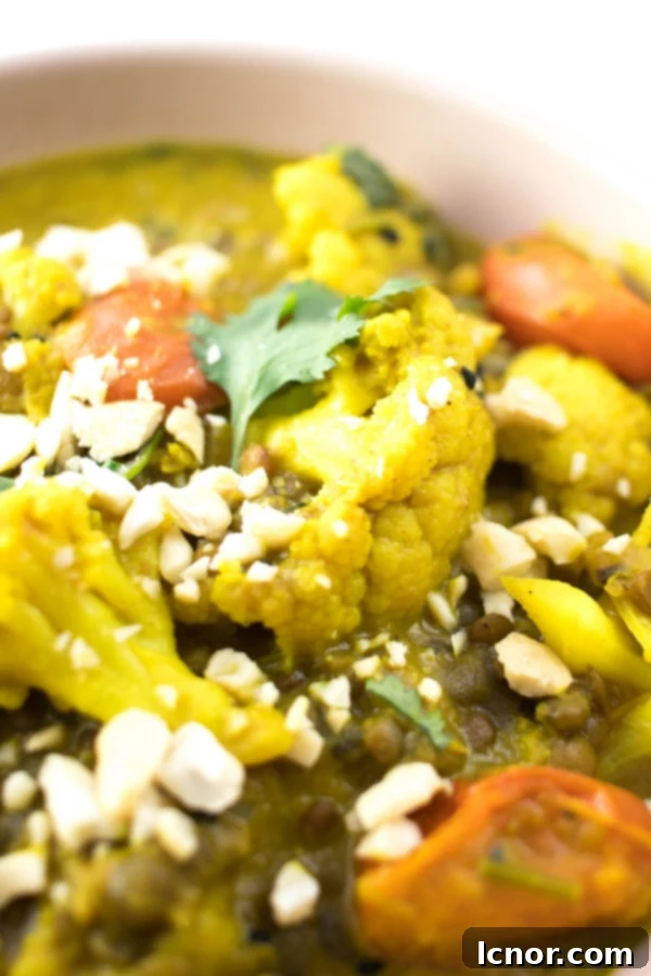 Beautifully presented Kerala Cauliflower Curry in a bowl, showing spices and ingredients