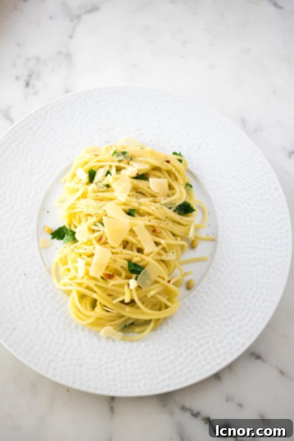 spaghetti with garlic and olive oil topped with parmesan and parsley
