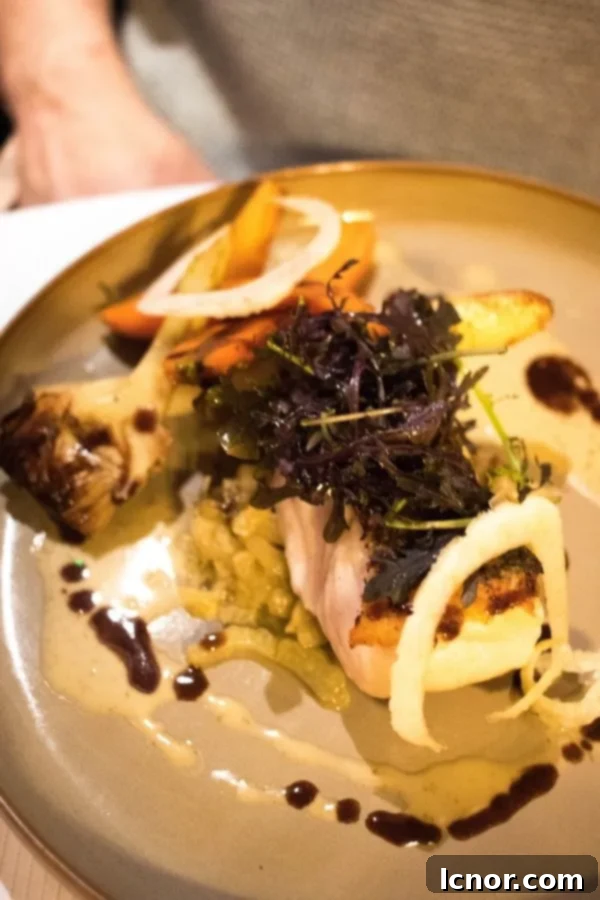Delicate white fish served with tender artichoke hearts and seasonal vegetables