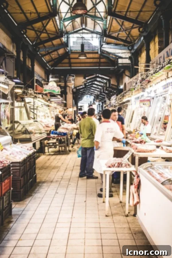 Athens Central Food Market: 10 Must-Visit Reasons 5 Inside the bustling meat hall at the Athens food market, showing butchers at work.