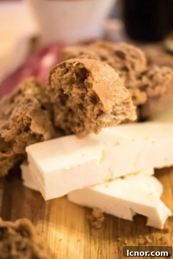 Wine tasting in Athens - a close-up of delicious Greek cheese on a wooden cutting board, part of a tasting spread.